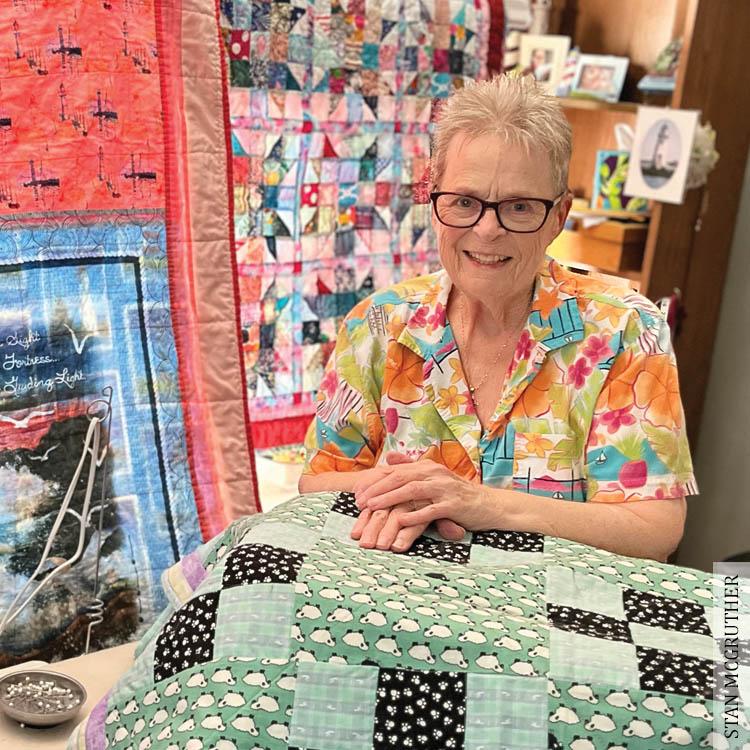 Woman sitting with colorful quilt in her lap
