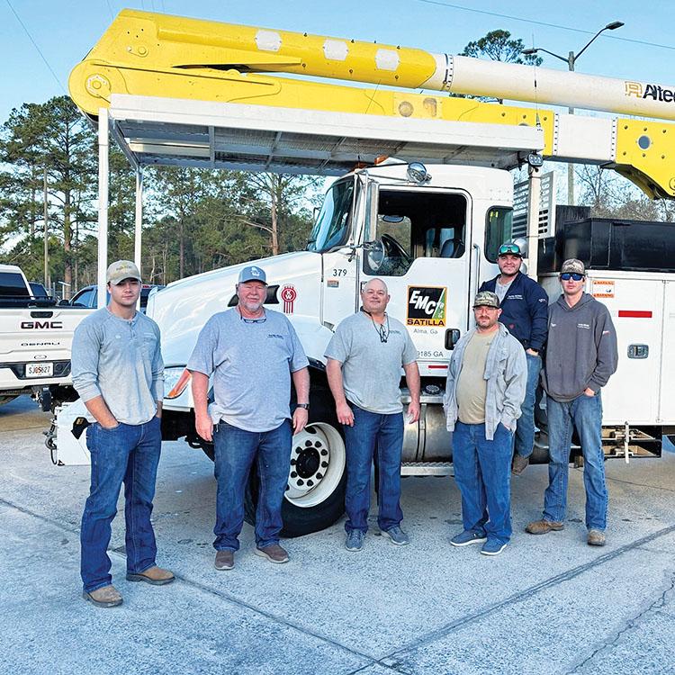 men in front of a bucket truck