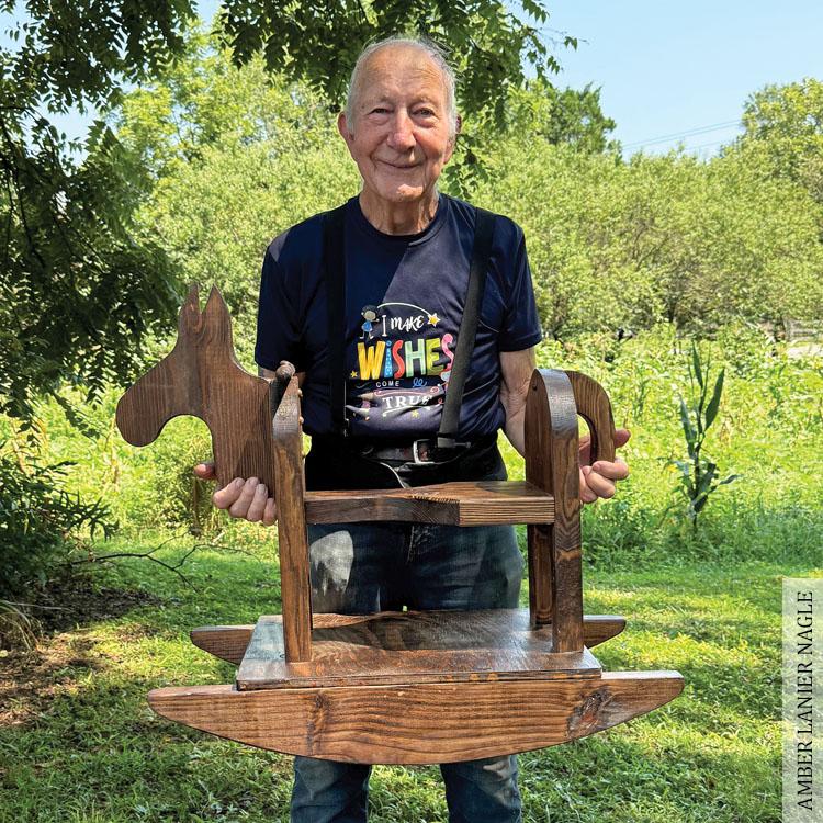 Garner standing with rocking horse