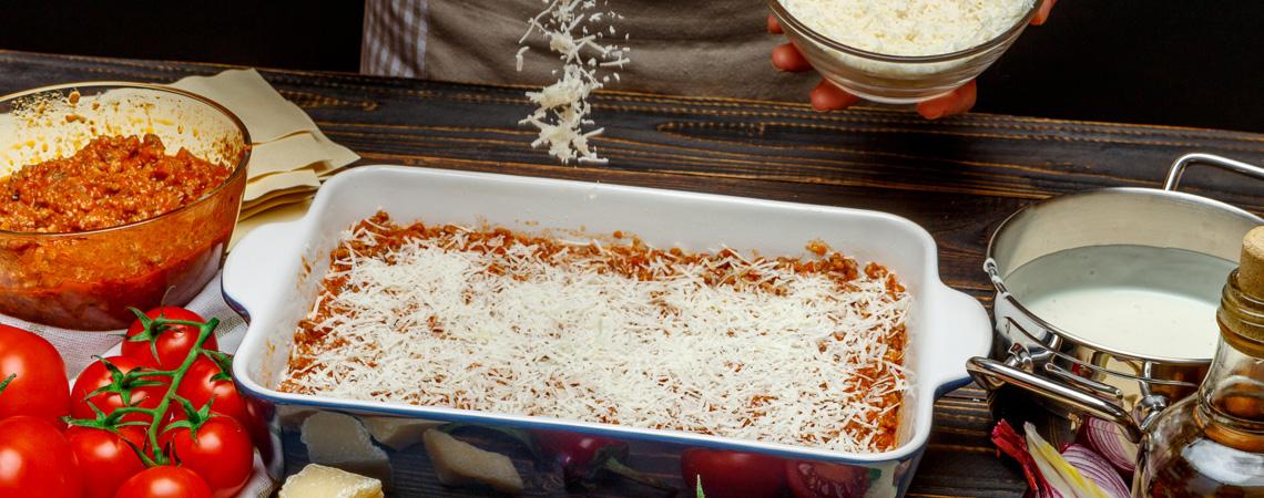 Pan of lasagna and ingredients in kitchen