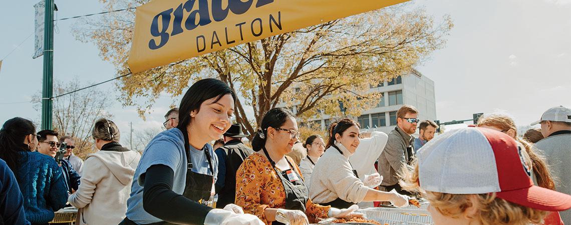 A volunteer serves a community Thanksgiving meal in Dalton Georgia