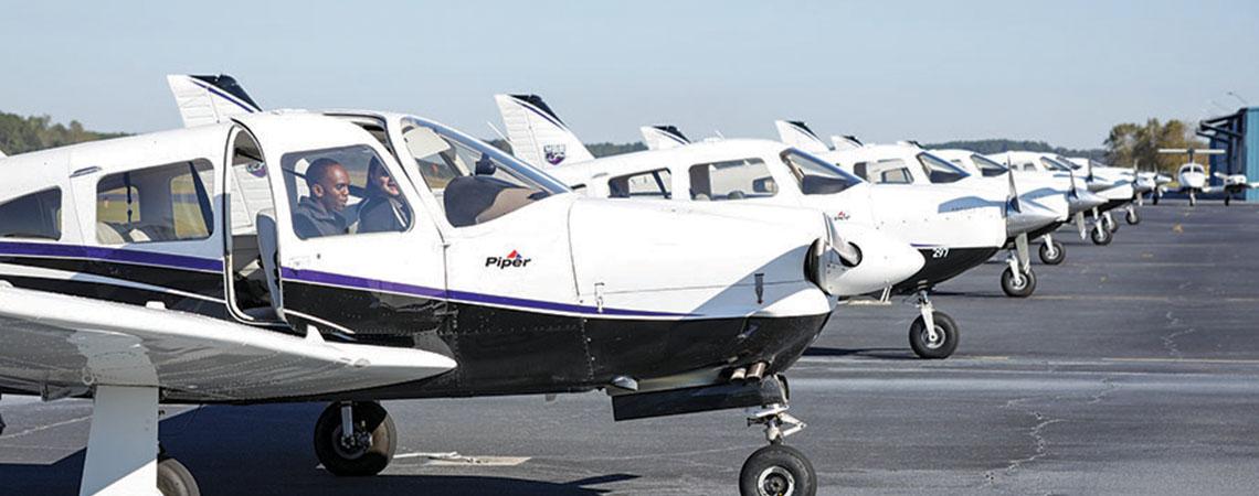 row of small planes on tarmac