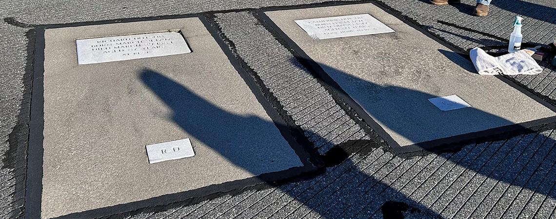 two cement graves embedded in runway