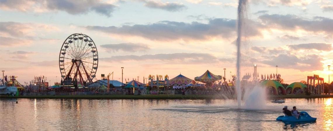 fair landscape with tents and rides
